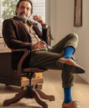 3. Lifestyle image Juzo Adventure Man wears the Juzo Adventure in blueberry and sits at his desk