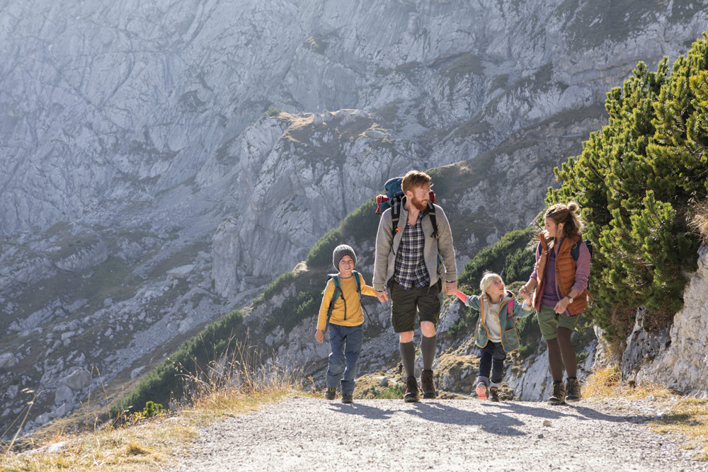 A family in the mountains. The parents are wearing compression stockings