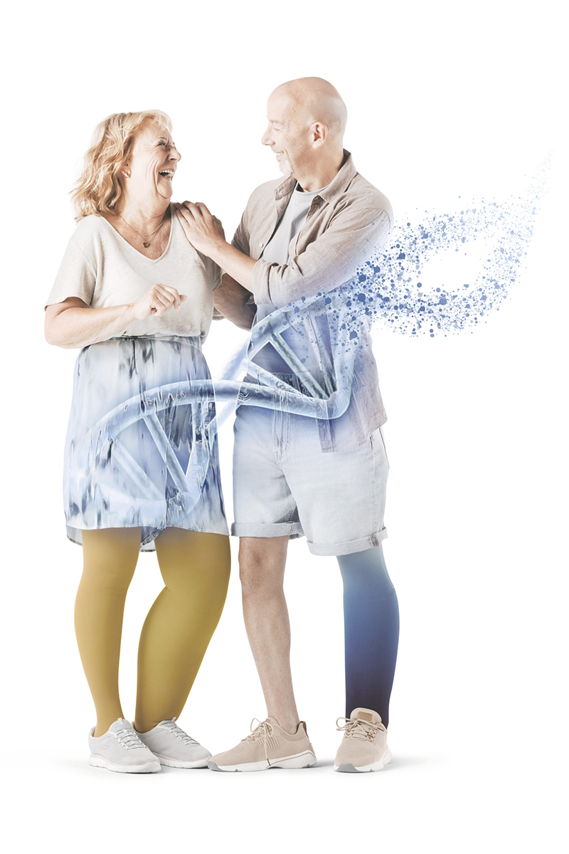Two people smiling at each other. In the foreground, a diagram of DNA
