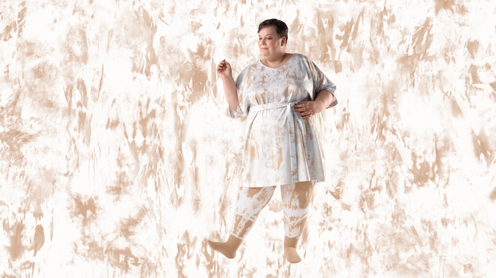 A woman wearing batik-patterned compression stockings against a batik-patterned background A woman wearing batik-patterned compression stockings against a batik-patterned background